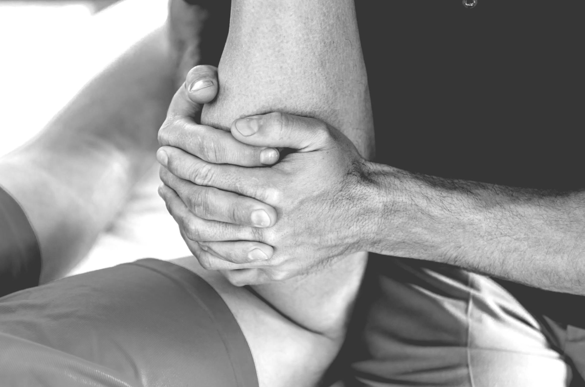A black and white photo of a person getting a massage.